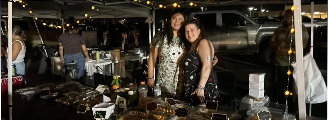 Samantha and Leslie of Horror Ghouls Bakery at their treat booth during a Yuma night market